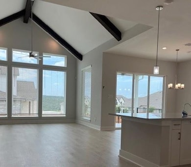 Kitchen with baseboards, light wood finished floo