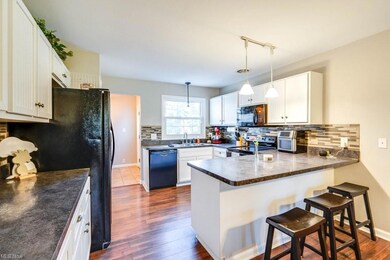 Kitchen featuring hanging light fixtures, backspla