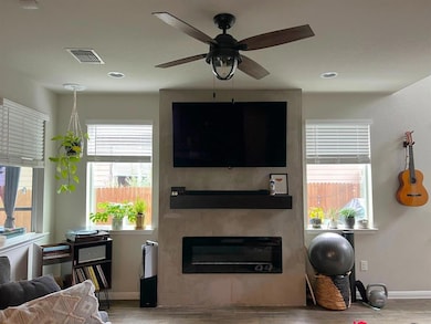 Living room with a fireplace, baseboards, wood fi