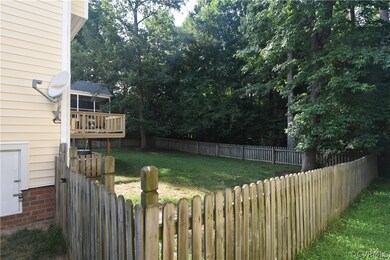 Yard view with wooded common area behind.