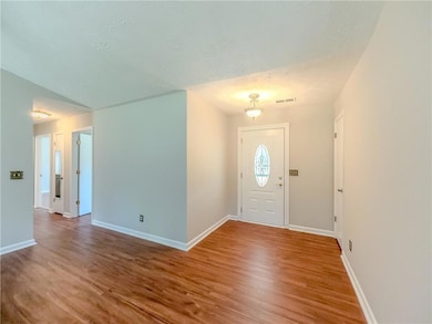 Foyer entrance featuring wood finished floors and 