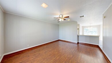 Spare room featuring ornamental molding, dark wood