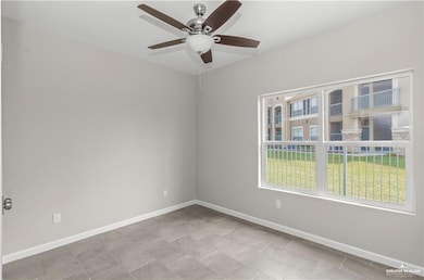 Unfurnished room featuring baseboards and a ceiling fan