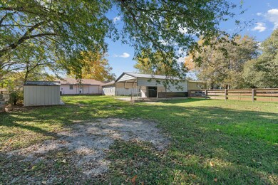 Back of property featuring a storage shed