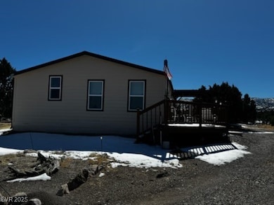 View of snowy exterior with a wooden deck