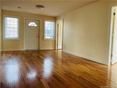 living room/ front door. recently renovated wood floors and newer paint!