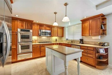 Stainless appliances include a Kitchen Aid double 