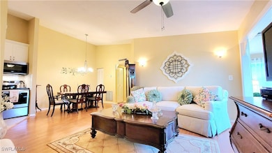 Living room featuring ceiling fan with notable cha
