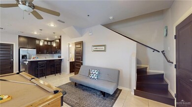 Living area with stairs, light tile patterned floors, ceiling fan, baseboards, and visible vents