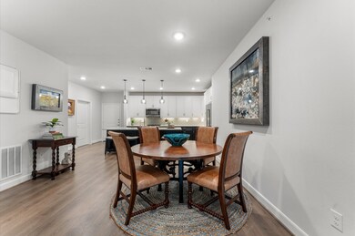 Photo showcases a modern open-concept dining and k