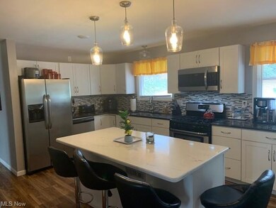 Kitchen with a wealth of natural light, hanging li
