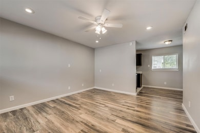 Unfurnished room featuring visible vents, baseboar