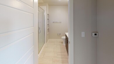 Bathroom featuring vanity, toilet, tile patterned 