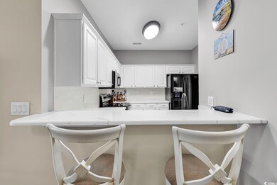 Kitchen with a kitchen breakfast bar, white cabine