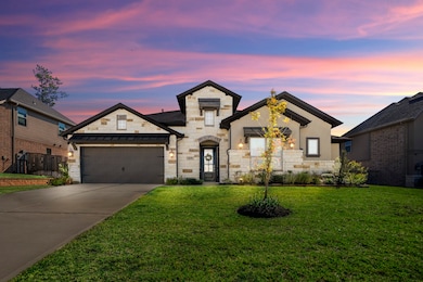 This like-new 1-story home features a modern design with stone and stucco exterior and 3-car garage.