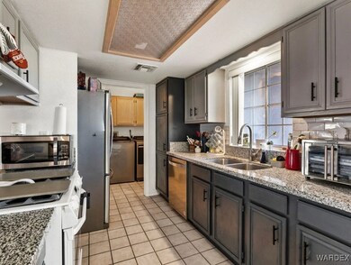 Kitchen with light stone counters, stainless steel