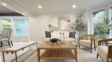 Sitting room featuring plenty of natural light, crown molding, wood finished floors, and recessed lighting