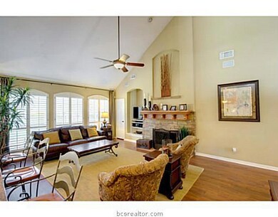 Living Room. Natural light from the floor to ceiling windows adds to the enjoyment of this living room which is beautifully finished with a custom stone faade fireplace, surround sound, and plantation shutters.