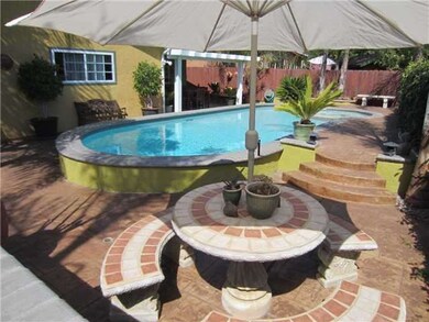Sparkling blue pool and spa. Custom concrete patio