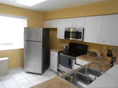 KITCHEN AREA WITH STAINLESS STEEL APPLIANCES AND P