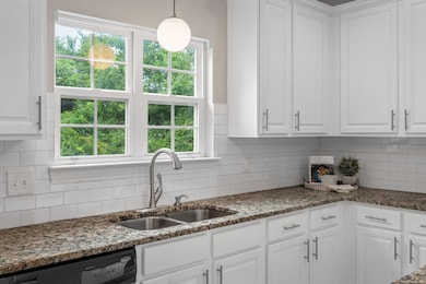 Granite counters, tile subway backsplash and updated lighting.