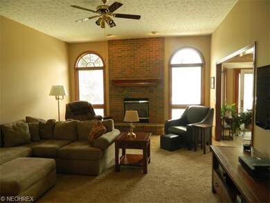Great room with new carpeting, beautiful brick fir