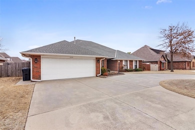 Single story home with driveway, brick siding, roo