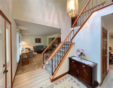 Foyer with oak and wrought iron railing done in 2023