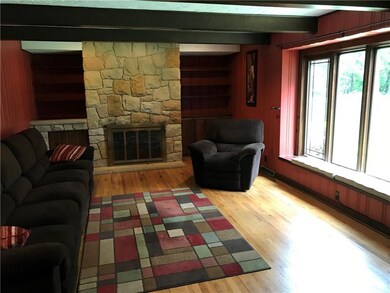 A stone fireplace flanked / built in shelves & a g