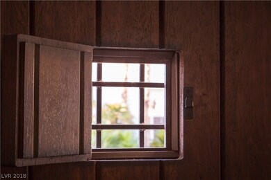STYLISH MAHOGANY FRONT DOOR WITH SPEAKEASY WINDOW.