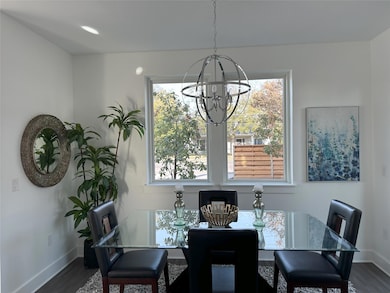Dining area with a chandelier, dark wood-style fl