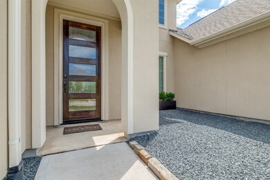 The entrance to your new home features a covered porch and beautiful front door