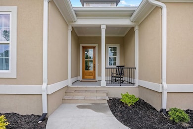 Entrance to property featuring stucco siding and beautifully tiled floor