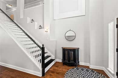 Staircase featuring wood finished floors and baseboards