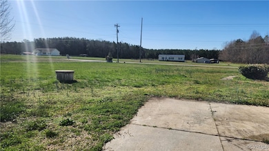 View of yard with a wooded view and a view of rura