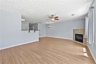 Unfurnished living room featuring visible vents, b