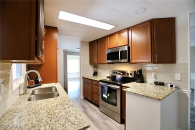 Kitchen featuring light stone counters, sink, tast