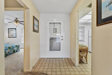 View of front door. There is a storm door in addition to the solid front door.