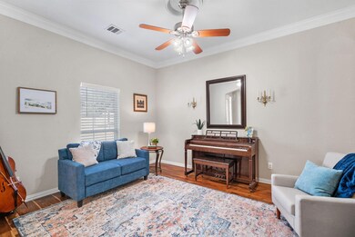 Wet bar, hardwood flooring, and ornamental molding