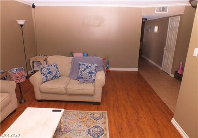 Living room view showing hallway to kitchen and fa