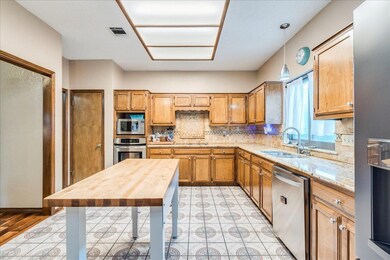 Kitchen with stainless steel appliances, a sink, 