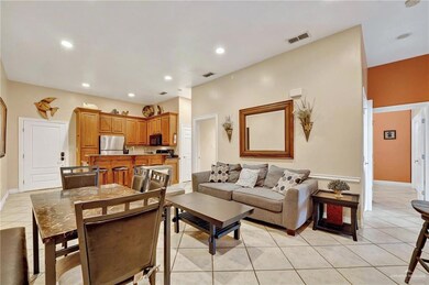 Living room with light tile patterned floors, recessed lighting, and baseboards