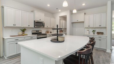 Kitchen featuring a kitchen breakfast bar, a cente