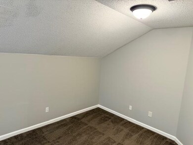 Bonus room featuring lofted ceiling, baseboards, d