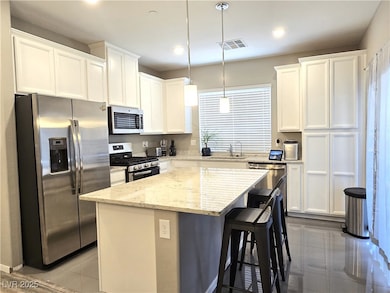 Kitchen with stainless steel appliances, a sink, a