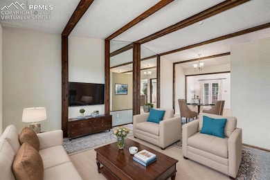 Open concept living room featuring charming beam ceilings