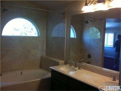 Master bath has walk in tub with jets.