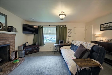 The living room includes a cozy, woodburning fireplace!