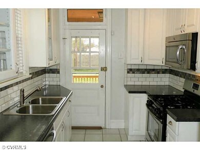 Kitchen - Kitchen leads out to rear porch, deck and terrace.  Great easy access to rear yard.  Note remodeled ktichen with new stainless appliances, tile back splash, track halogen lighting and custom cabinetry.