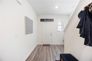 Foyer entrance featuring wood finished floors, baseboards, and recessed lighting